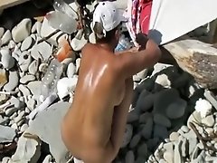 Spying on sexalicious woman sun bathing on a nudist beach