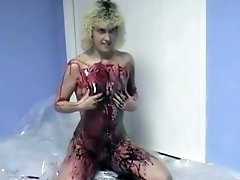 Curly-haired amateur blonde smears her body with paint indoors